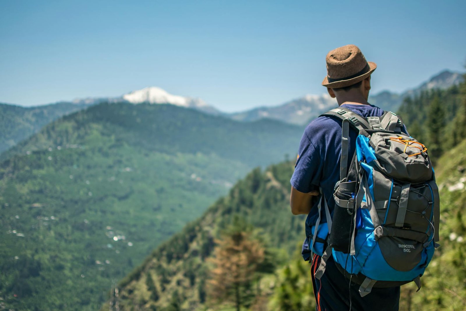 selective focus photography of man carrying hiking pack